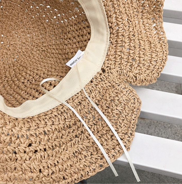 Sammenleggbar dame solhatt med bred brem. Reisevennlig design for enkel pakking og UV-beskyttelse på farten.