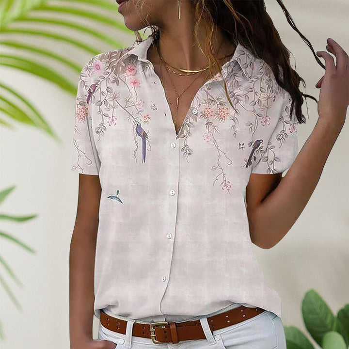 Rosa kvinners kortermet bluse med blomstertrykk, ideell for varme sommerdager.