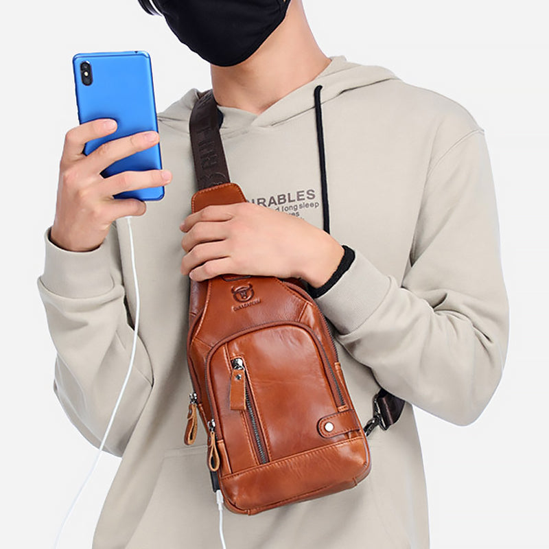 Praktisk rødbrun cross-body herreveske i ekte skinn, for daglig organisering.