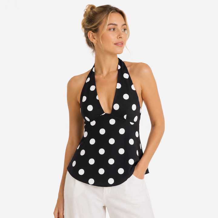 Elegant prikkete haltertopp for dame, med ryggløs design og søt sløyfedetalj. Perfekt sommertopp.