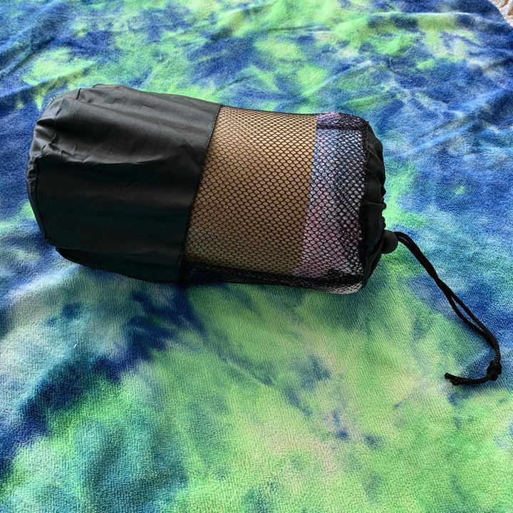 Stilrent rundt piknikteppe med frynser. Et must-have strandutstyr for sommerdager ved sjøen.
