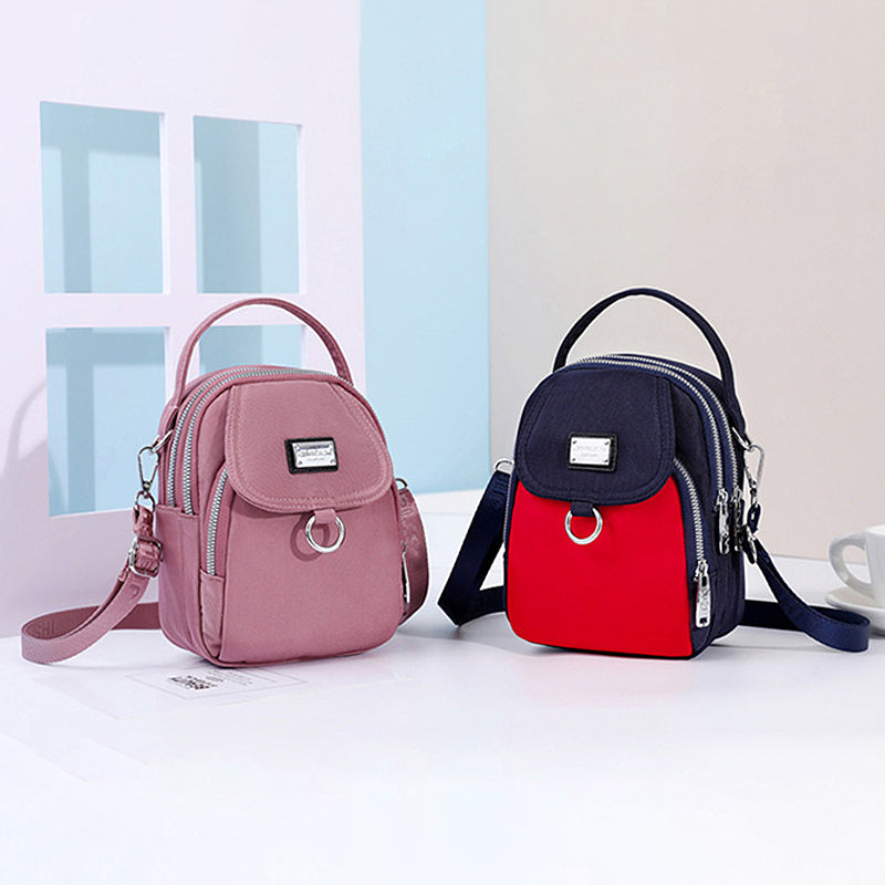 Allsidig dameveske: vanntett crossbody i slitesterk nylon med solid glidelås.
