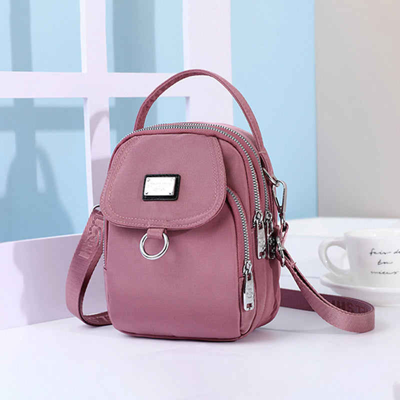 Smart shoppingveske: vanntett crossbody med glidelås, perfekt for damer på farten.