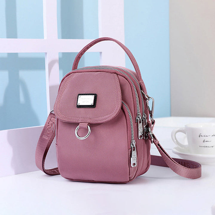Smart shoppingveske: vanntett crossbody med glidelås, perfekt for damer på farten.