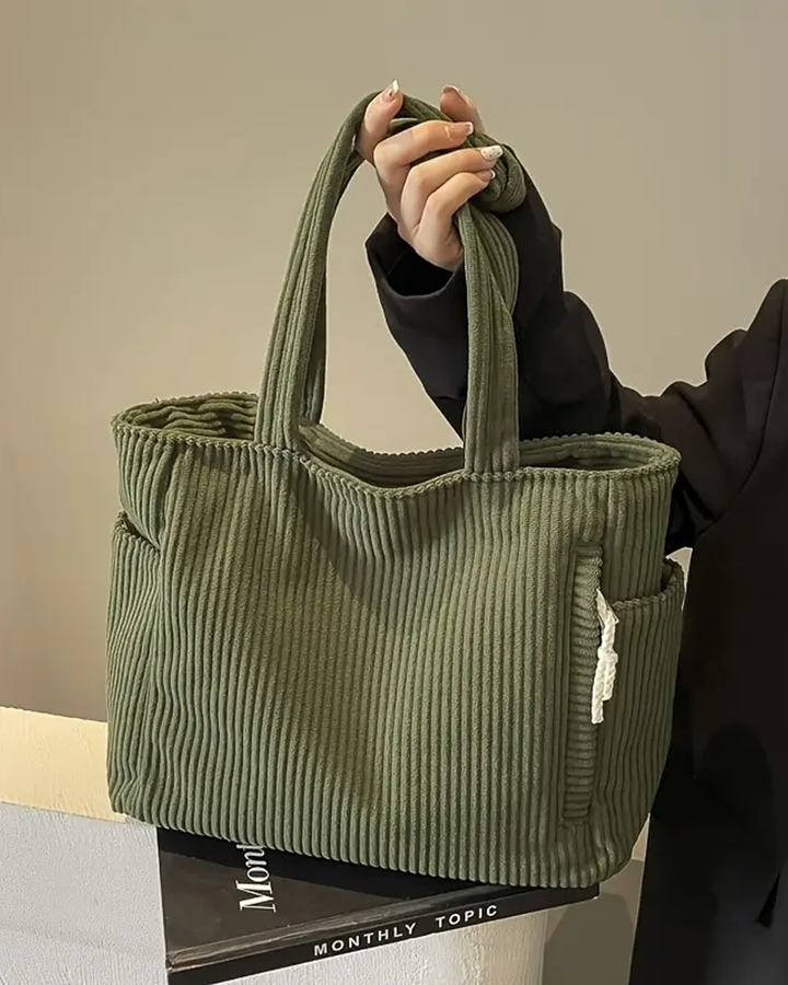Elegant dame hverdags skulderveske med stilfull snordetalj. Romslig design for daglig bruk.