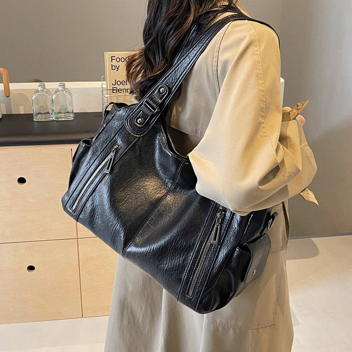 Elegant PU-skinn håndveske, stor kapasitet og praktisk for en travel hverdag.