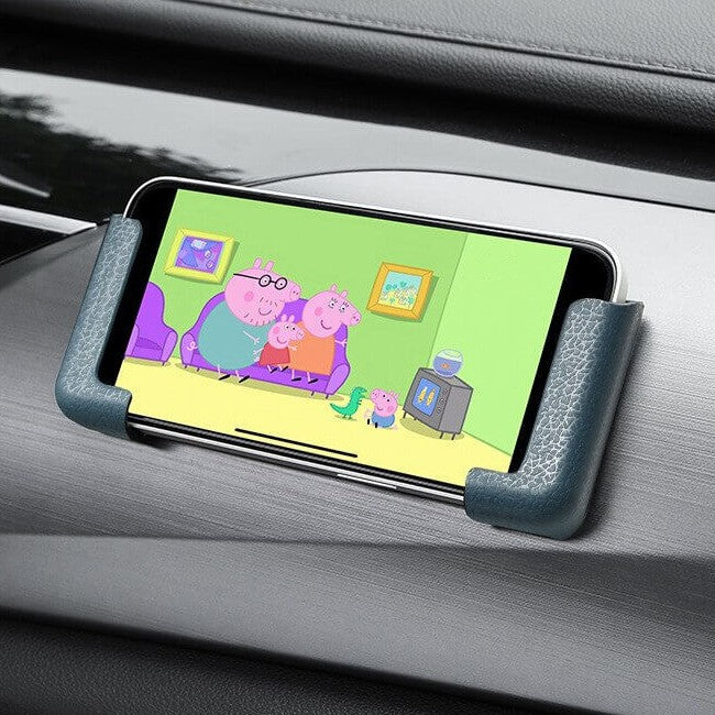 Universell smarttelefonholder med selvklebende bakside. Kompatibel med de fleste telefoner i bil eller hjem.