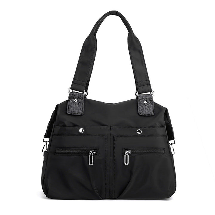 Komfortabel vanntett nylon skulderveske. Damerveske med sikker laptoplomme for hverdagsbehov.