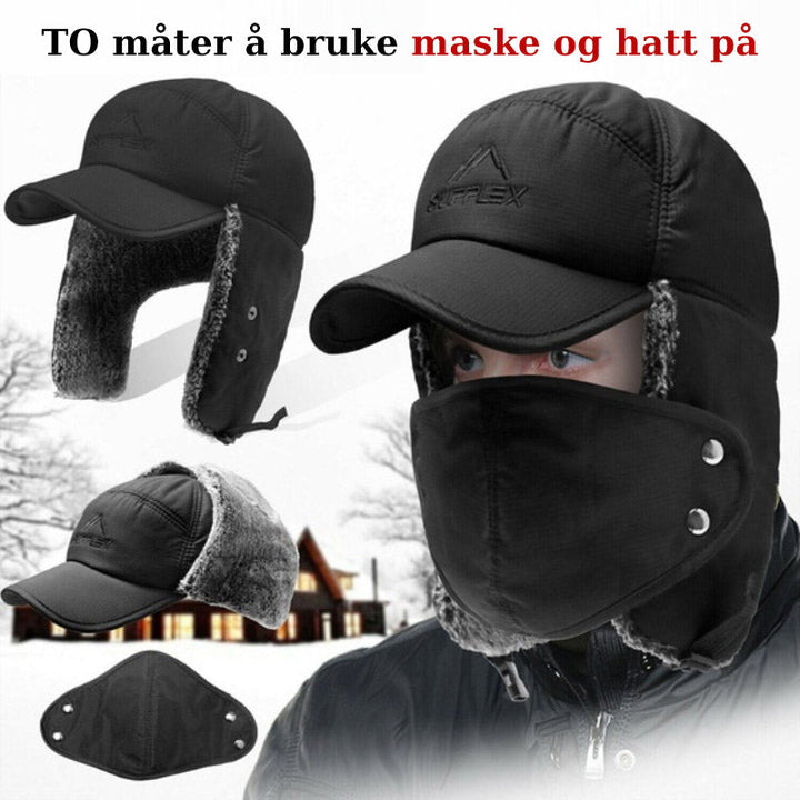 Person iført varm, vindtett unisex vinterlue med ansiktsbeskyttelse i snøen, hodeplagg for utendørs.