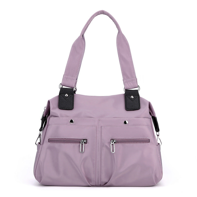 Sikker vanntett nylon laptopveske for kvinner. Beskytter innholdet som en pålitelig skulderveske.