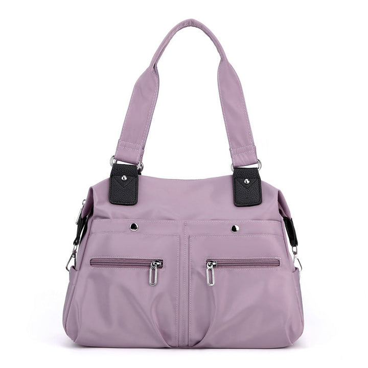Sikker vanntett nylon laptopveske for kvinner. Beskytter innholdet som en pålitelig skulderveske.
