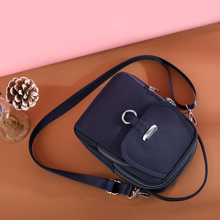 Moteriktig damveske, crossbody stil. Vanntett nylon for organisert oppbevaring på farten.