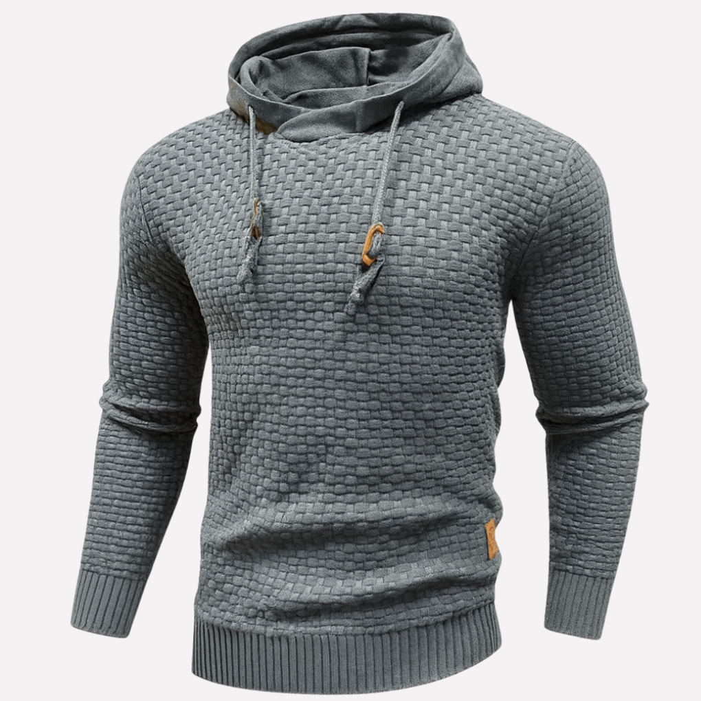 Mann iført grå hettegenser. Komfortabel pullover for en avslappet hverdag.