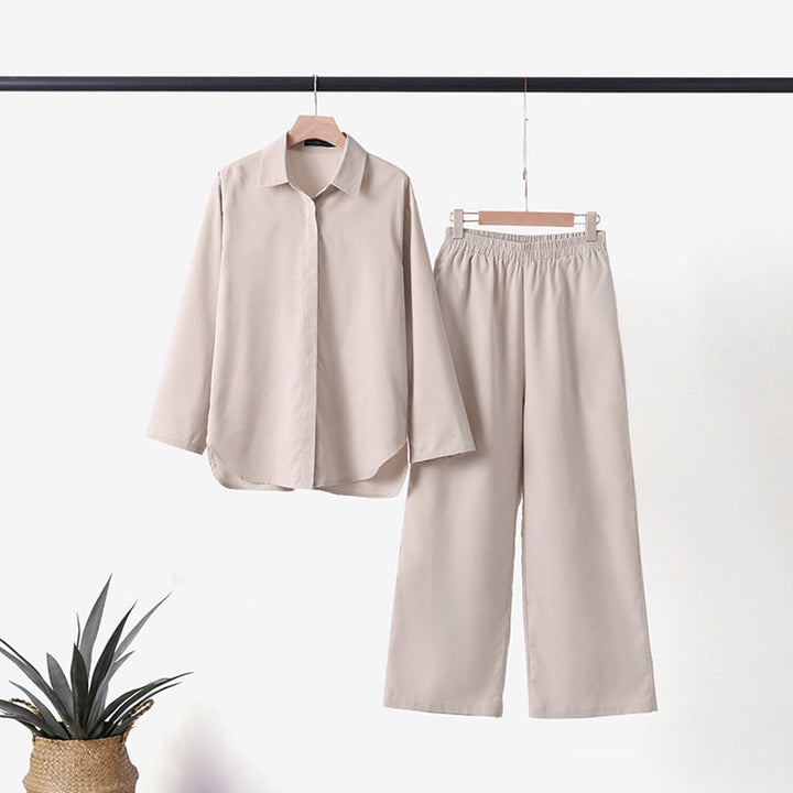 Ensfarget langermet fritidsdress for kvinner. Komfortabel bluse og vide bukser for en avslappet hverdagsstil.