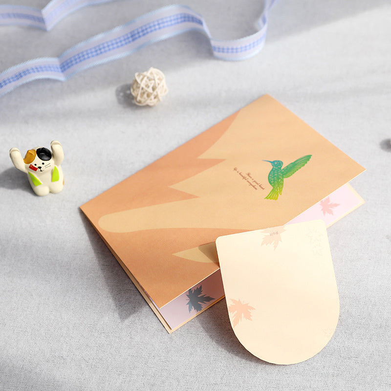 Elegant pop-up gratulasjonskort med flygende kolibri og fargerike liljeblomster for morsdag.