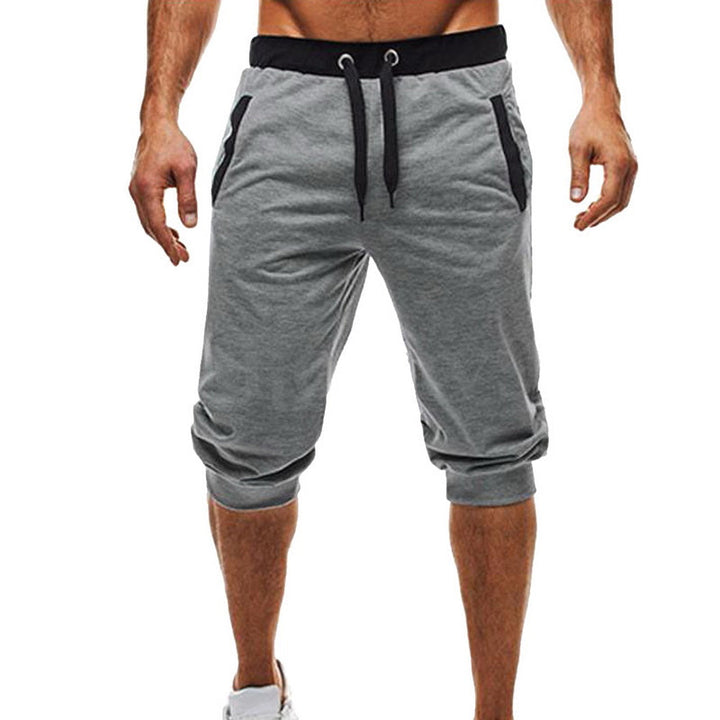 Elastiske polyester treningsbukser for menn med snøring, gir optimal bevegelsesfrihet under aktivitet.