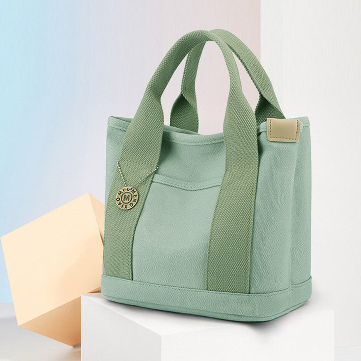 Elegant dameveske i slitesterk canvas, perfekt for jobb og fritid.