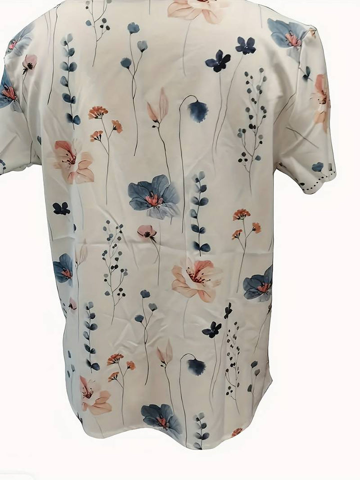 Komfortabel damebluse med elegant blomstermønster og feminint snitt.