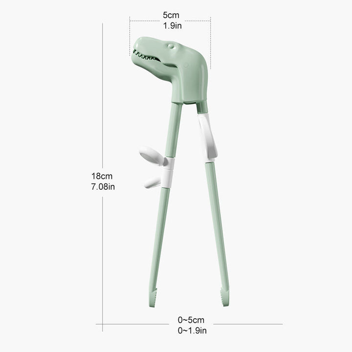 Spisepinner for barn med dinosaur design på en fargerik tallerken, gjør måltider appetittvekkende.
