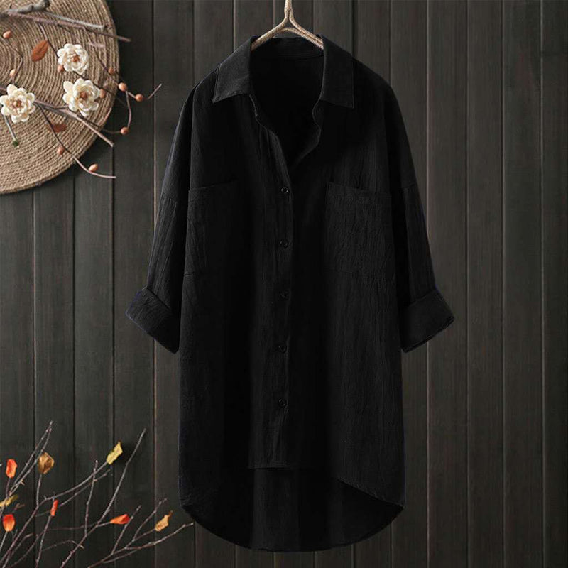 Elegant damebluse med knapper, lange ermer og løs passform. Ensfarget design for stil og komfort.