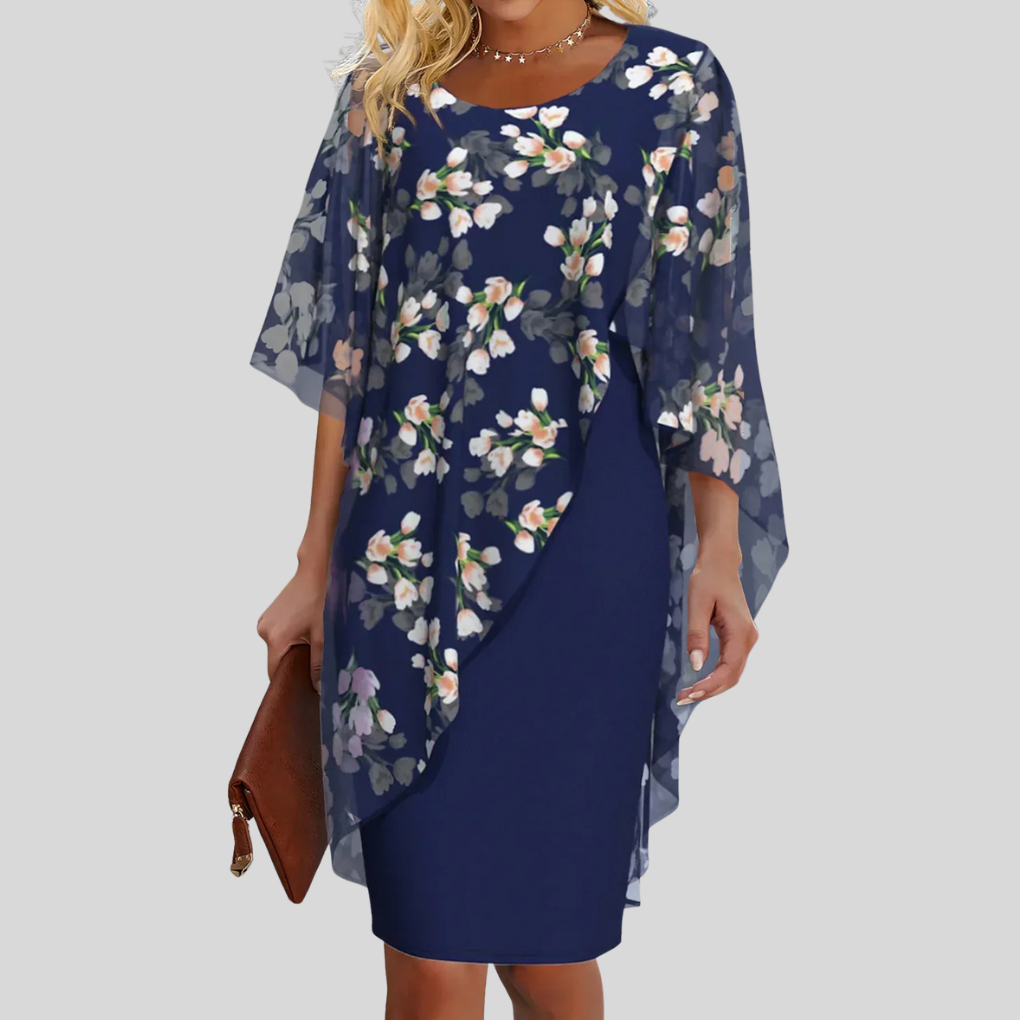 Elegant ermeløs dame chiffonkjole med delikat blomstermønster og A-linje passform, perfekt til fest og sommer.