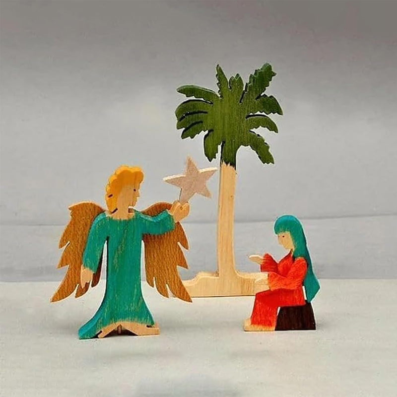 Julekrybbe i tre, plassert på et vakkert juledekorert bord. Skaper hyggelig julestemning.