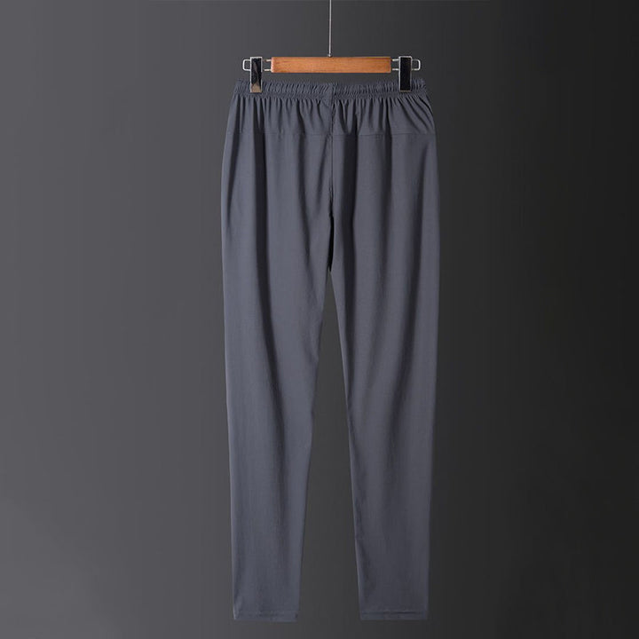 Hurtigtørkende, pustende fritidsbukse for sporty menn og kvinner. Elastisk og komfortabel joggebukse for alle dager.