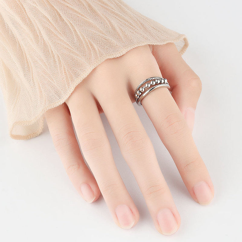 Beroligende unisex ring i sølvfarge med spinnende perler, bra for fokus og angst.