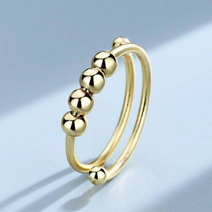 Detalj av beroligende dame fidget-ring; roterende elementer for angstlindring og fokus. Gaveidé.