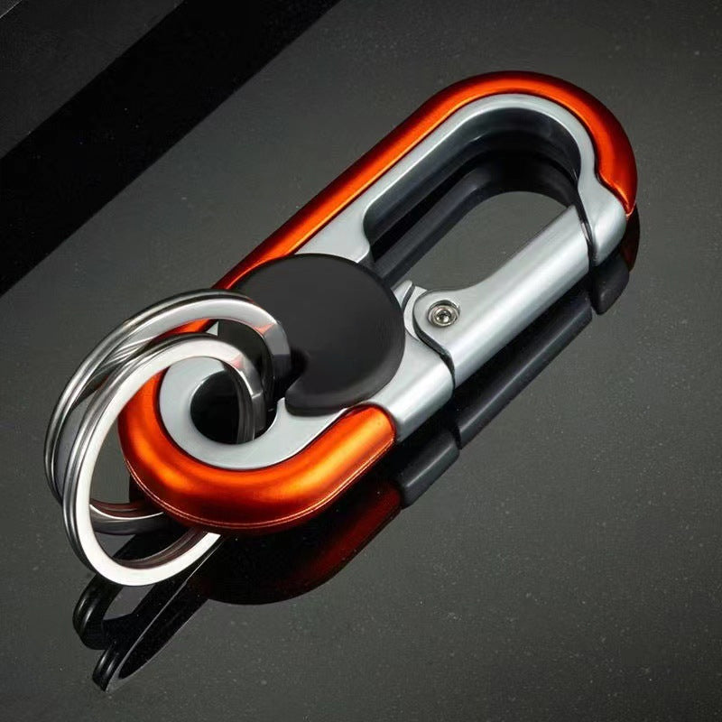 Detaljert bilde av robust bilnøkkelring i blått og oransje, viser solid sinklegering og stål.