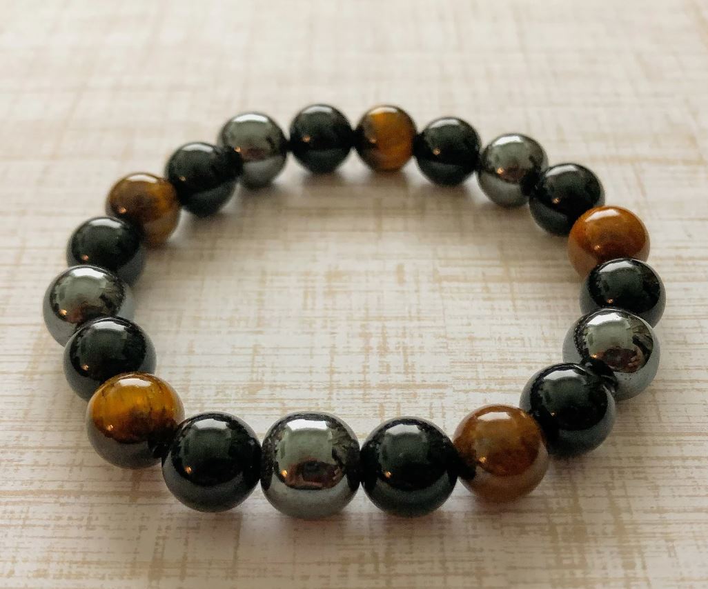 Nærbilde av unisex natursteinarmbånd. Detaljer av tigerøye, obsidian, hematitt for balanse og beskyttelse.