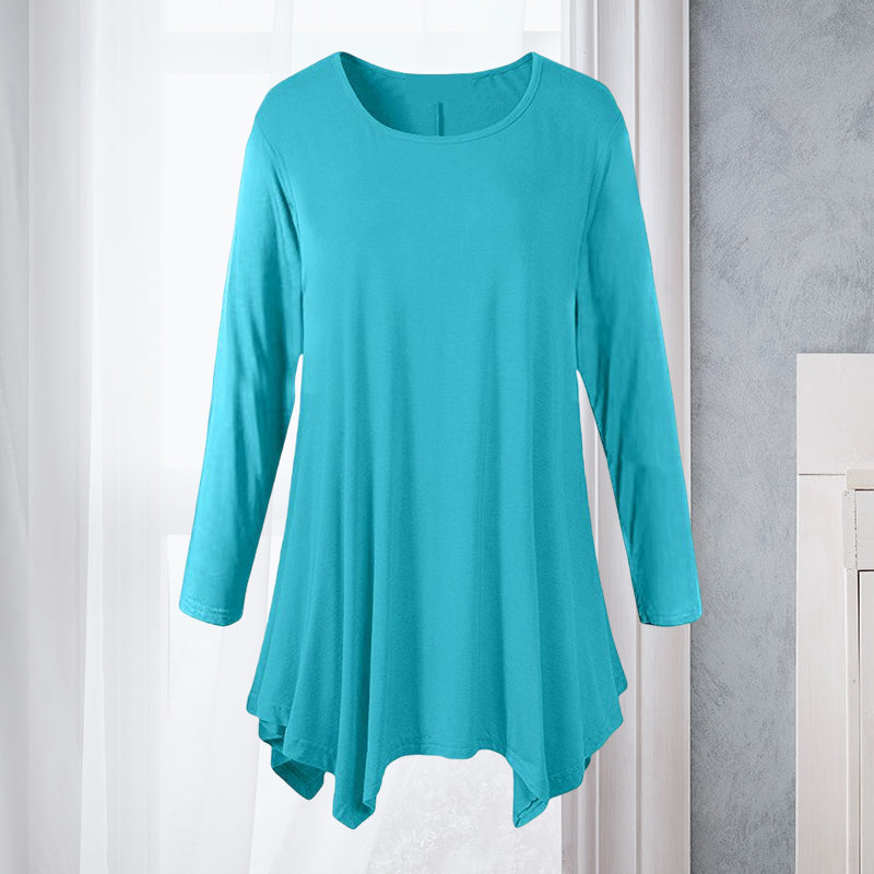 Feminin ensfarget bluse med rund hals og lange ermer. Løs passform, perfekt for casual dameklær.