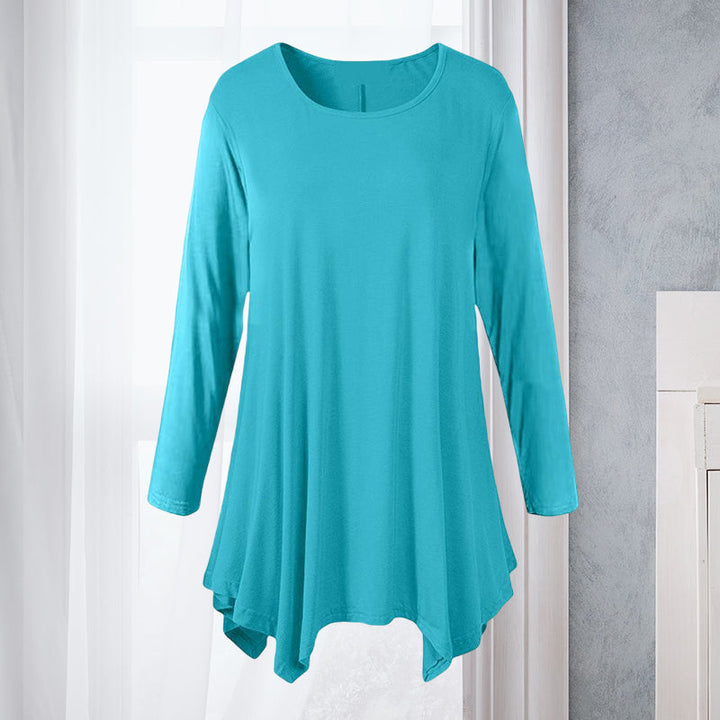 Feminin ensfarget bluse med rund hals og lange ermer. Løs passform, perfekt for casual dameklær.