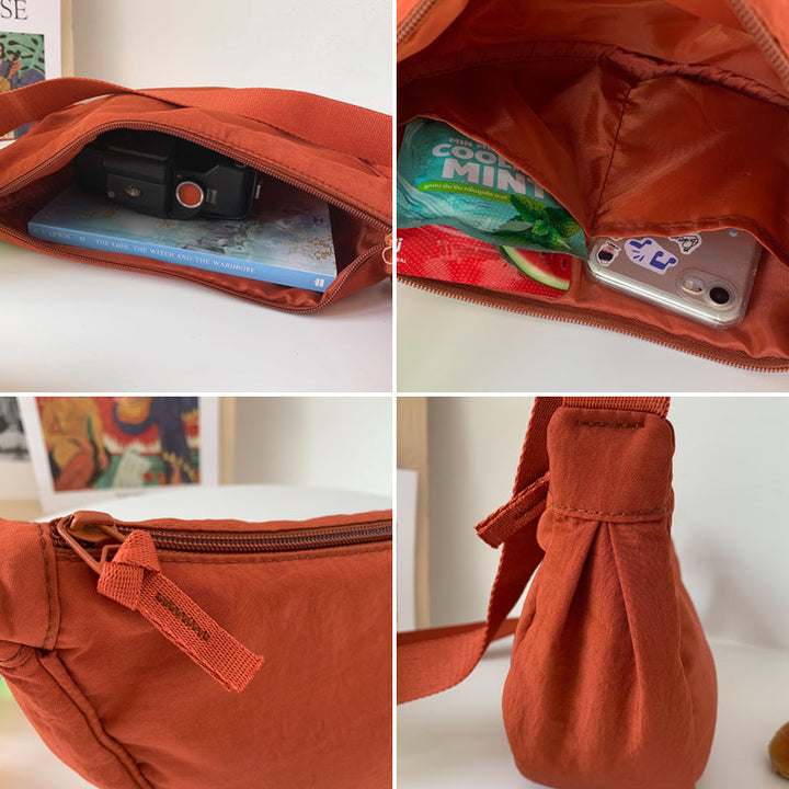 Kompakt halvmåne reiseveske i nylon, unisex crossbody, sikker og enkel tilgang til eiendeler.