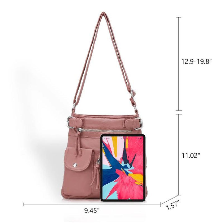 Åpen dame crossbody-veske som viser romslig interiør med flere lommer for enkel organisering.