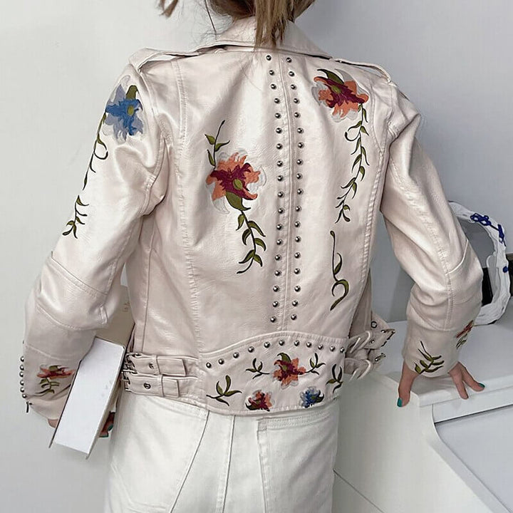Bikerstil damejakke med utsøkt blomsterbroderi, asymmetrisk glidelås og fald.