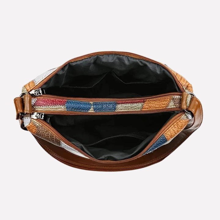 Elegant kvinners veske med unikt lappeteppe-design, en stilfull hverdagsveske i vegansk skinn som kan brukes som crossbody.