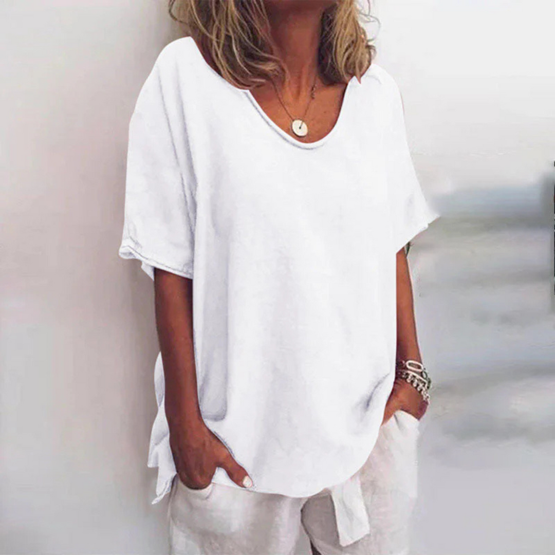 Elegant og løs damebluse med lange ermer og V-hals. Ideell for en avslappet, men stilfull look.
