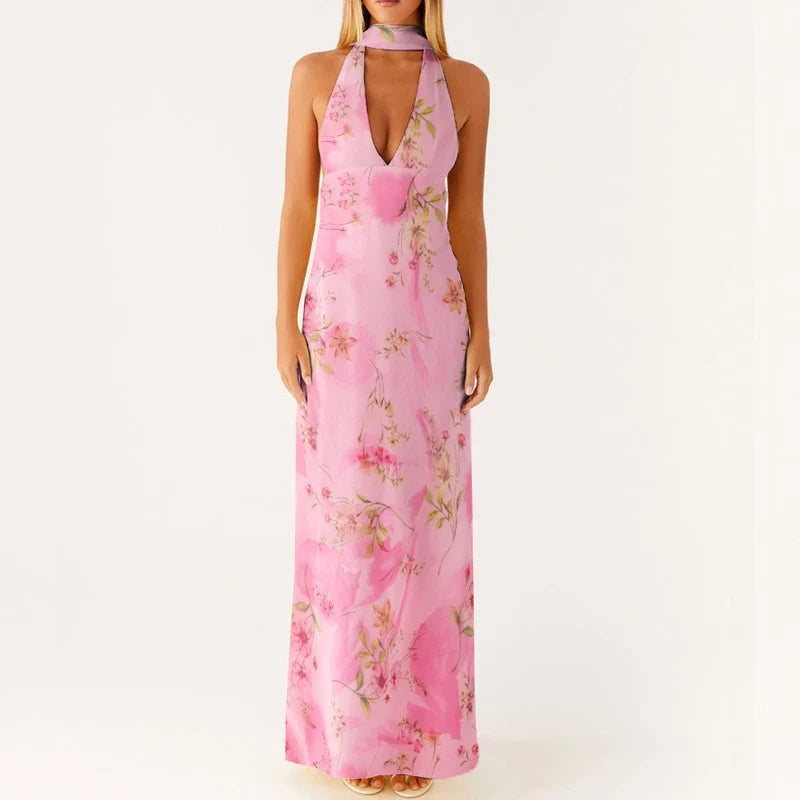 Ermeløs halterneck maxikjole for kvinner. Elegant design med åpen rygg for en perfekt sommerstil.