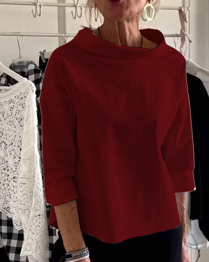 Klassisk dame topp med høy krage. Langermet og elegant, en tidløs garderobefavoritt.