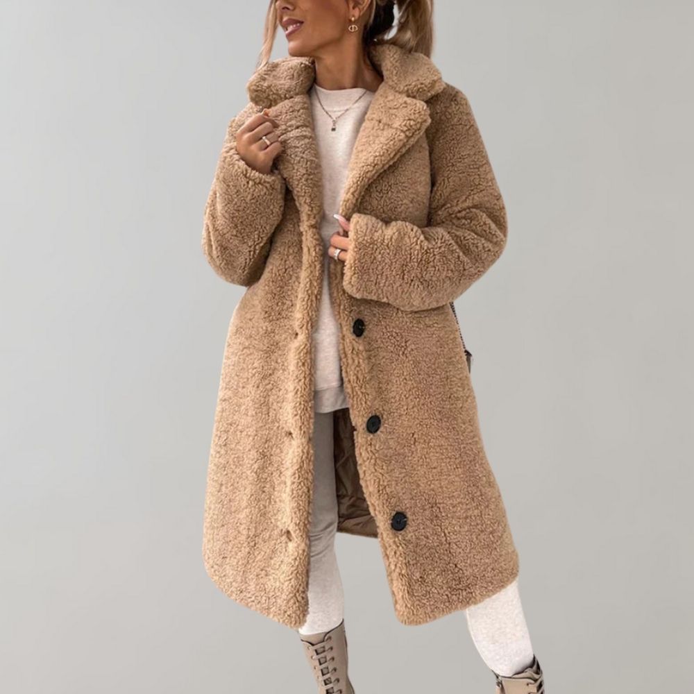 Nærbilde av stoffet på en varm, lang damefrakk. Stilren og elegant vinterkåpe for kvinner.