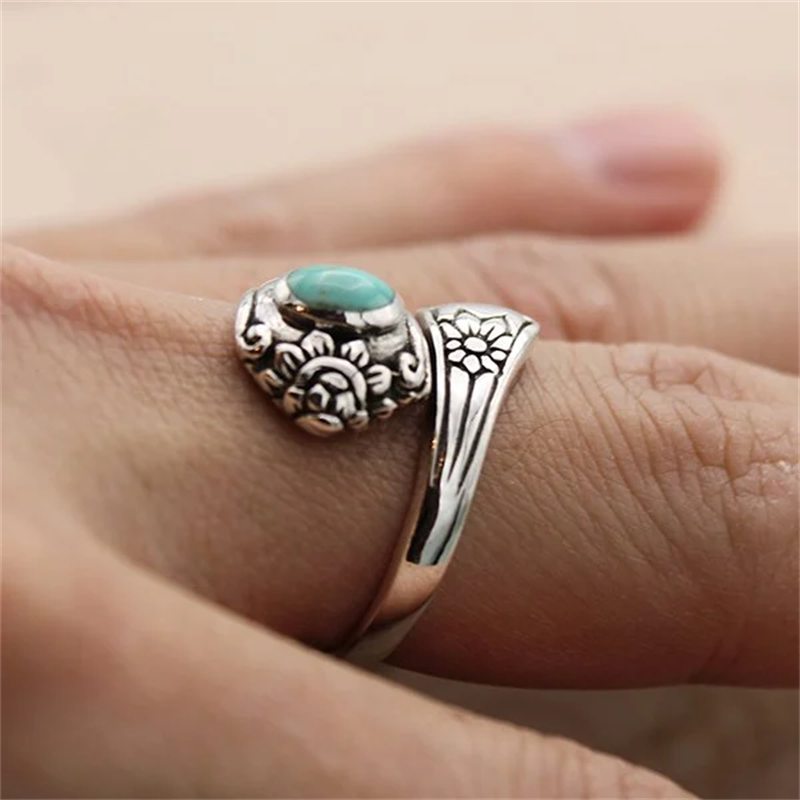Nærbilde av beroligende turkis edelsten i en intrikat vintage ring, justerbar for enhver finger.