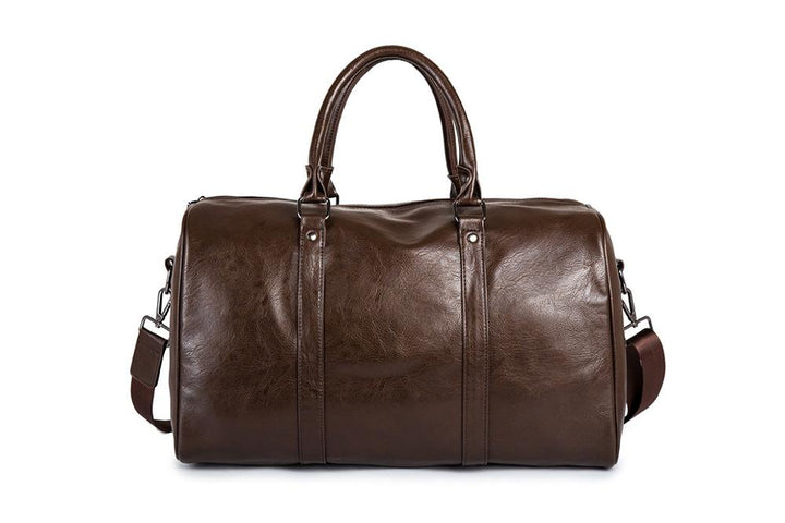 Åpen svart duffelveske i PU-skinn som viser romslig interiør, perfekt som weekendbag og håndbagasje.