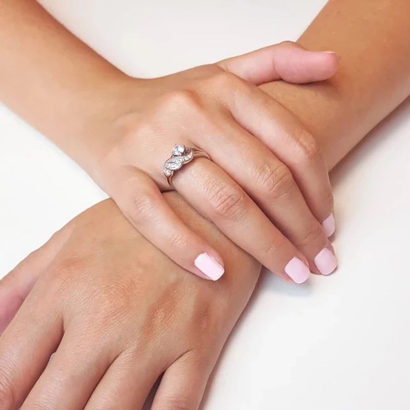 Strålende dame ring med symbolsk englevinge og gnistrende cubic zirconia. For enhver anledning.