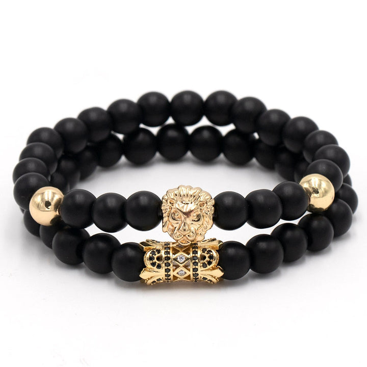 Unisex løvearmbånd med sorte perler og gullfarget løvehode. Symboliserer styrke og selvtillit.