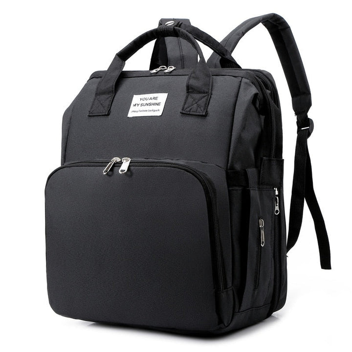 Multifunksjonell reiseveske med integrert babyseng, perfekt for babyreise og foreldre. Inkluderer stellematte.