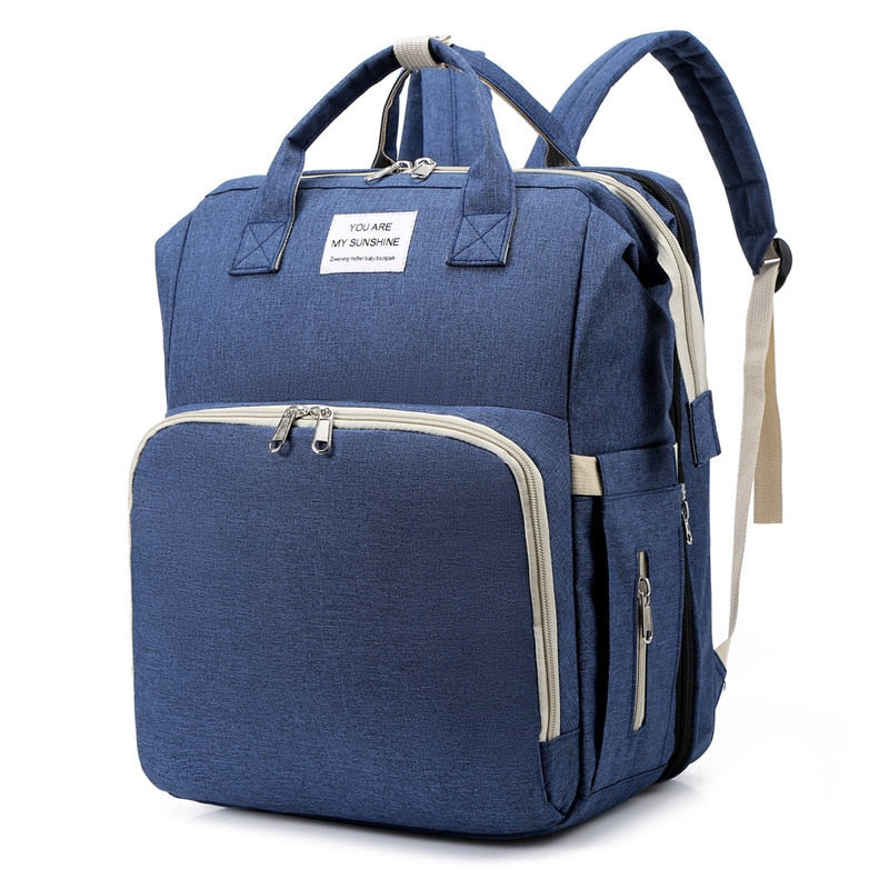 Smart organizer reiseveske med integrert babyseng og stellematte for enkel og organisert babyreise.