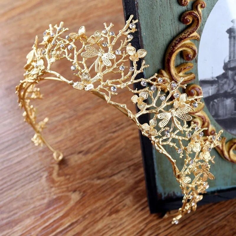 Elegant brudetiara i gull med glitrende rhinestones og detaljerte øyenstikkere. Ideelt for bryllup.