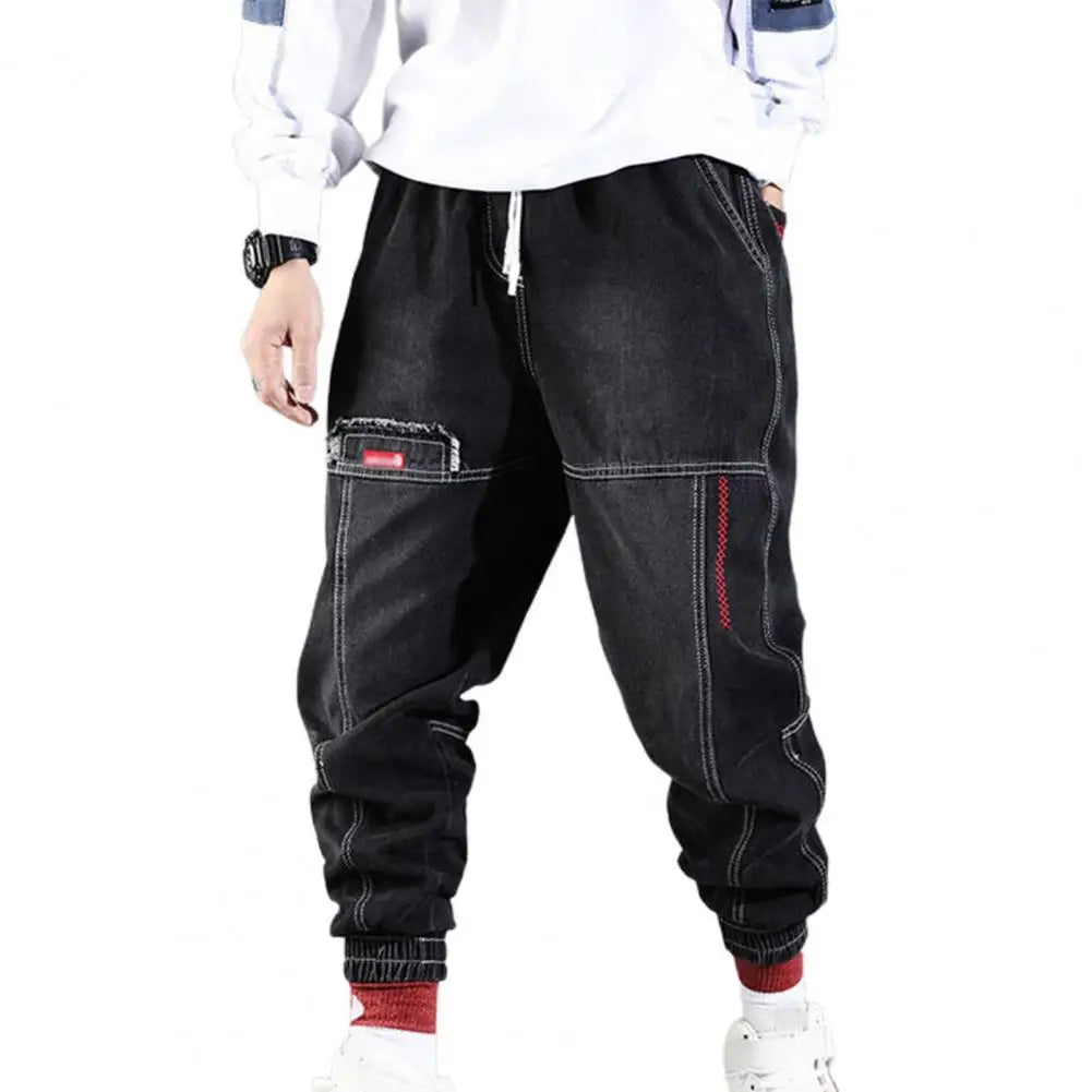 Moderne streetwear haremsbukser i bomull for menn. Løs passform, praktiske lommer, perfekt for casual bruk.