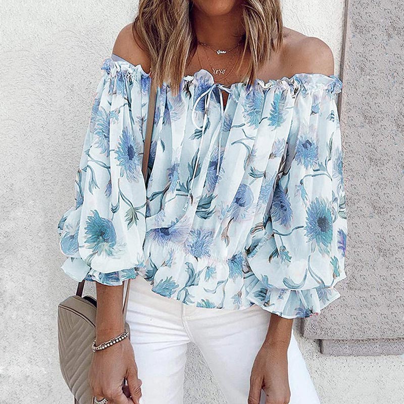 Elegant damebluse med blomstermønster, off-shoulder design og volangkanter. Perfekt for fest.